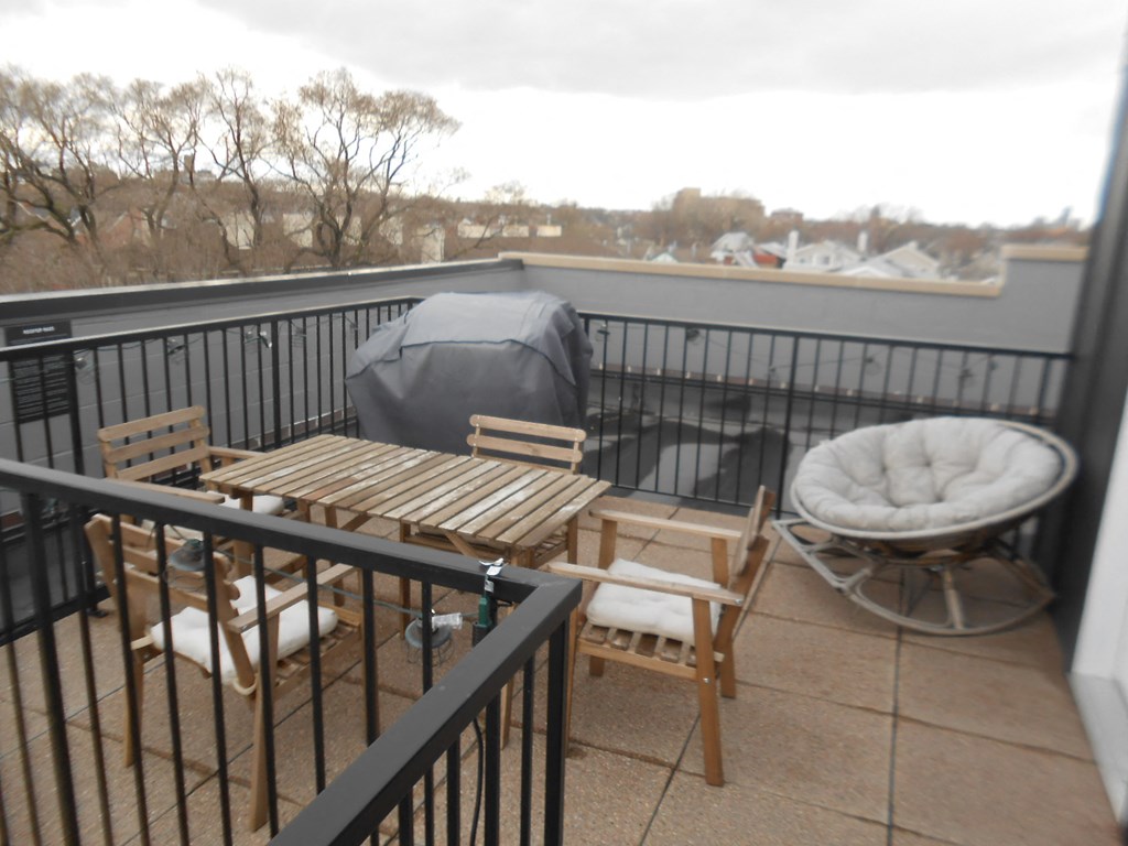 a patio with a table and chairs on a balcony