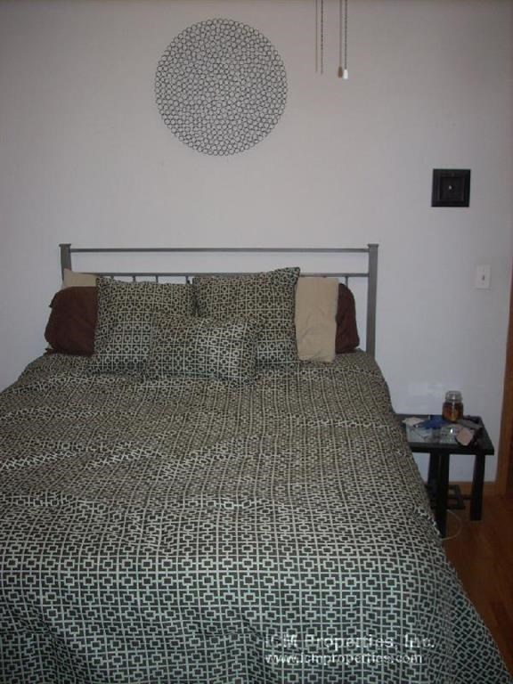 a bedroom with a bed with pillows on it