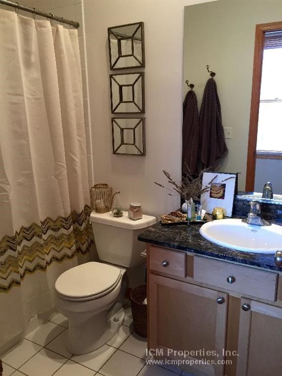 a bathroom with a toilet and a sink and a shower