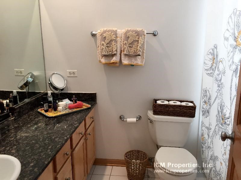 a bathroom with a toilet and a sink and a mirror