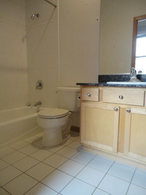 a bathroom with a toilet and a tub and a sink