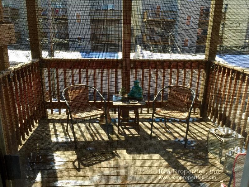 a patio with two chairs and a table