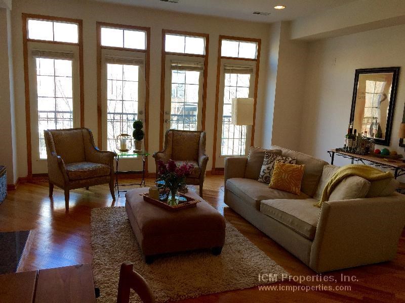 a living room with a couch and two chairs