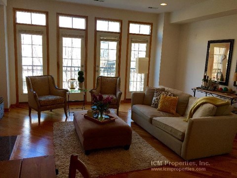 a living room with a couch and two chairs