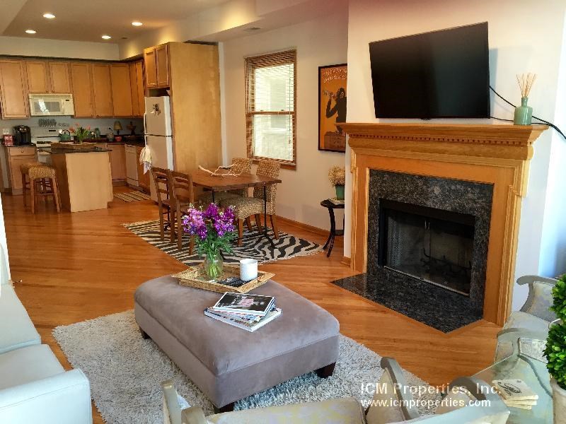 a living room with a fireplace and a tv