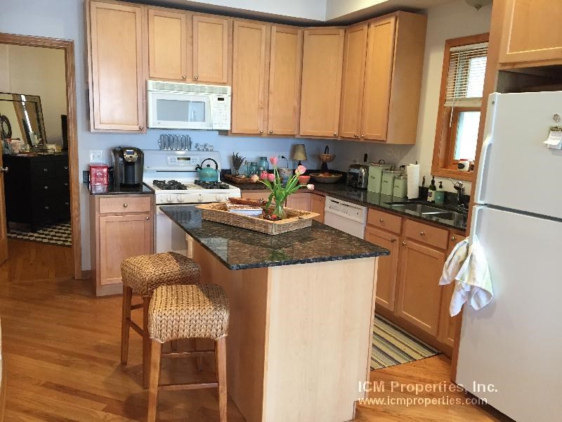 a kitchen with wooden cabinets and a counter top