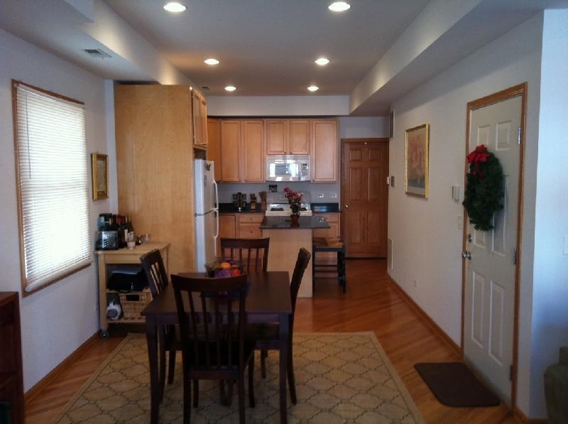 a large kitchen with a table and chairs