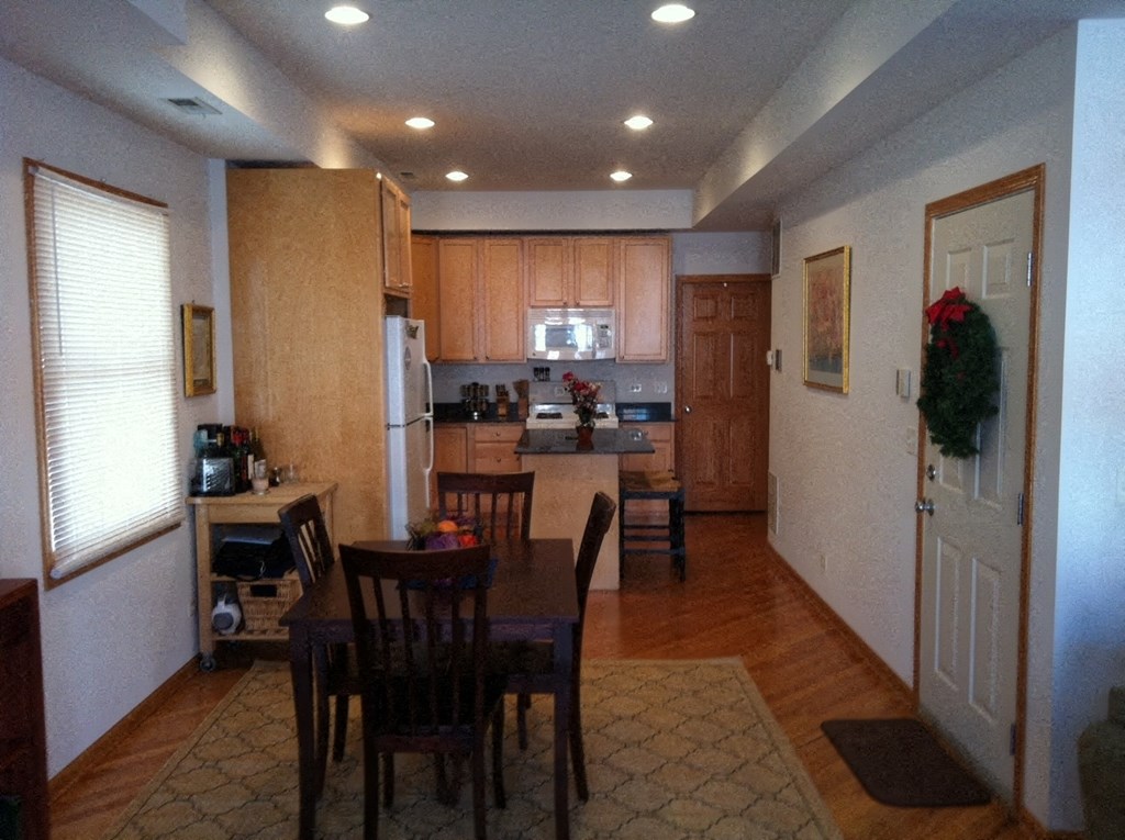 a kitchen and dining room with a table and chairs