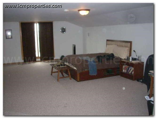 a living room with a couch and a bed