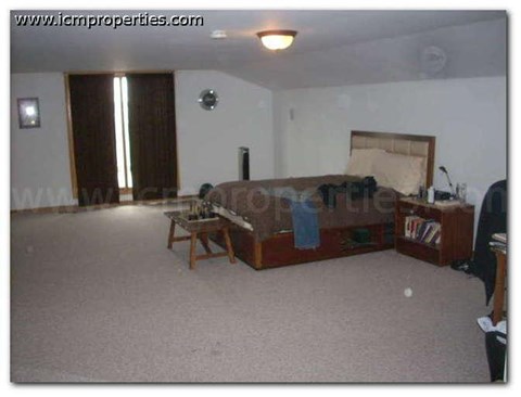 a living room with a couch and a bed