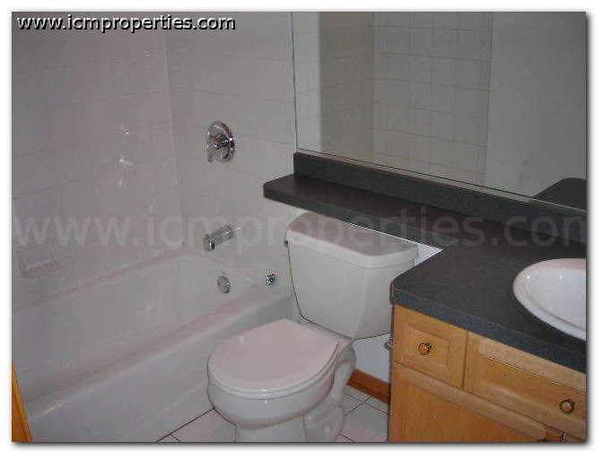 a bathroom with a toilet and a tub and a sink