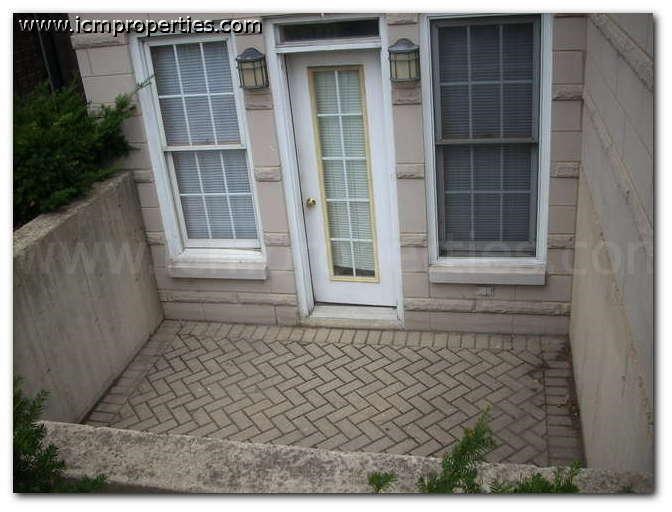 a front porch of a house with a door and windows