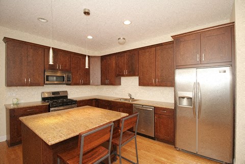 a kitchen with wooden cabinets and stainless steel appliances