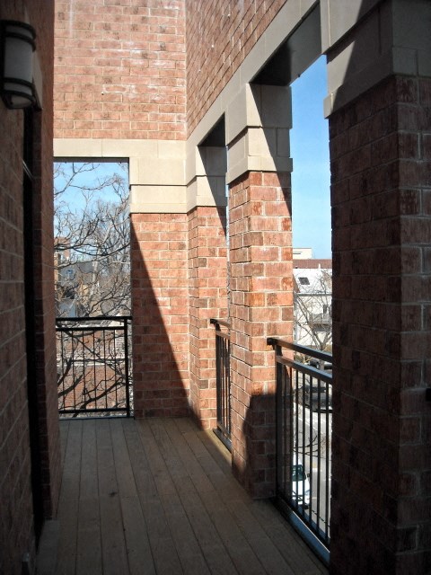 the view from the balcony of a brick building