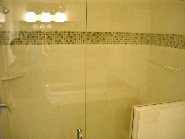 a shower with a glass door in a bathroom