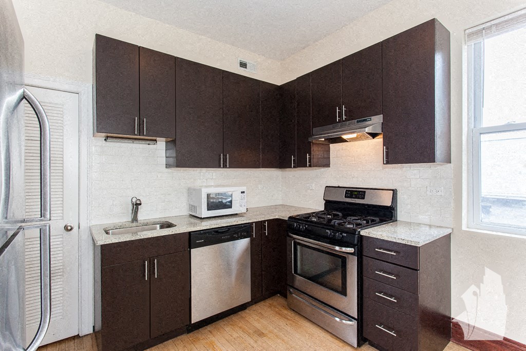 a kitchen with a stove and a refrigerator