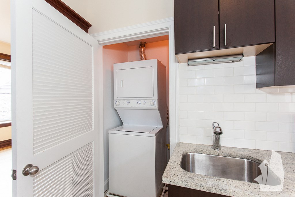 a small kitchen with a washing machine and a sink