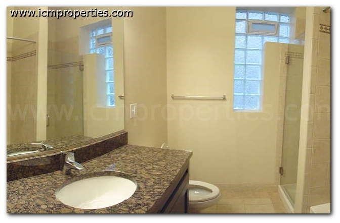 a bathroom with a sink and a shower and a toilet