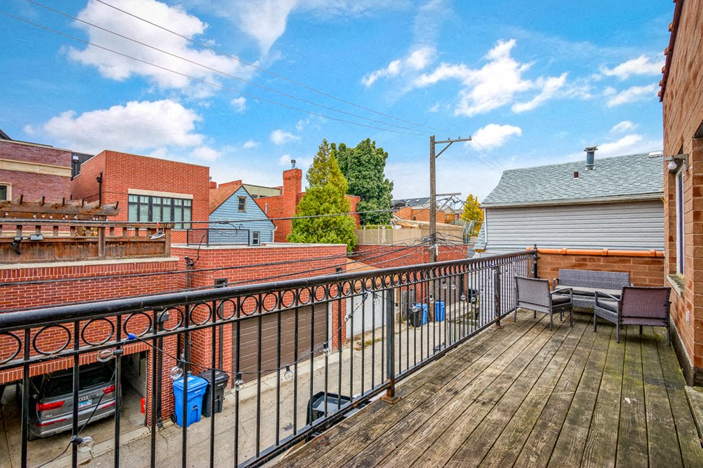 a balcony with a wooden deck and a fence