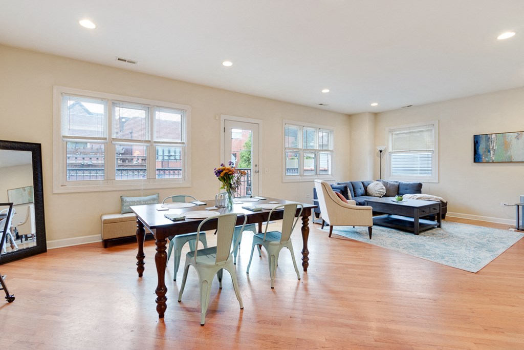 a dining room and living room with a table and chairs