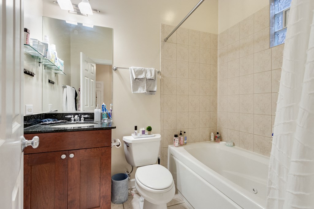 a bathroom with a toilet and a tub and a sink