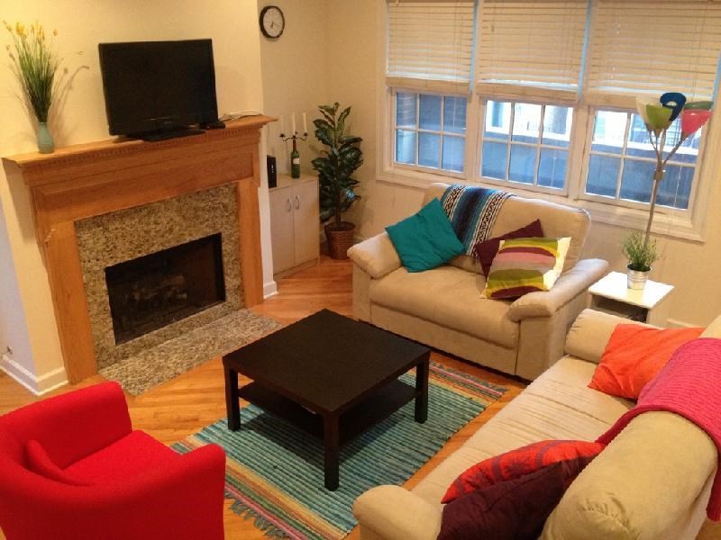 a living room with a couch and a table and a fireplace