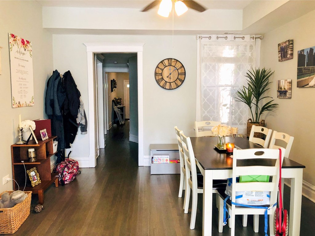a living room and dining room with a table and chairs