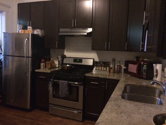 a kitchen with stainless steel appliances and black cabinets