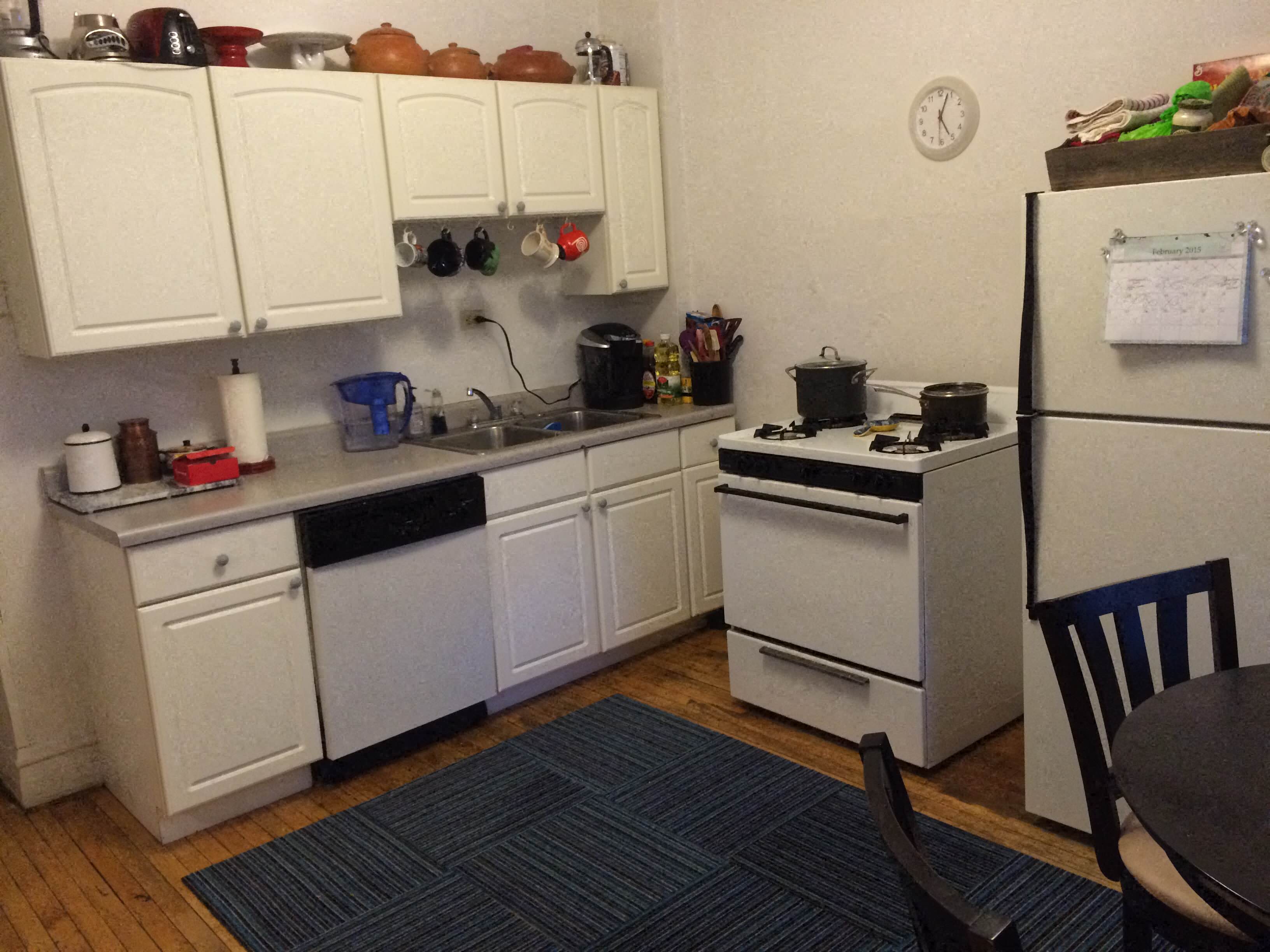 a small kitchen with a stove refrigerator and sink