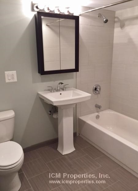 a bathroom with a sink toilet and a mirror