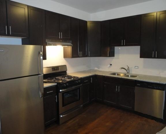a kitchen with stainless steel appliances and black cabinets