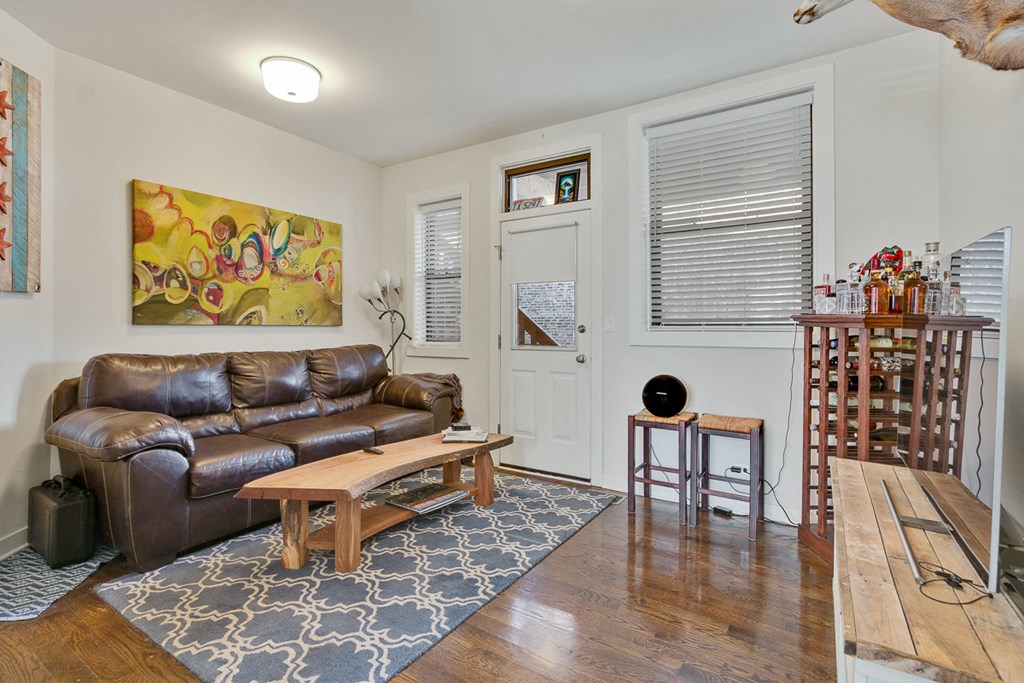 a living room with a leather couch and a table