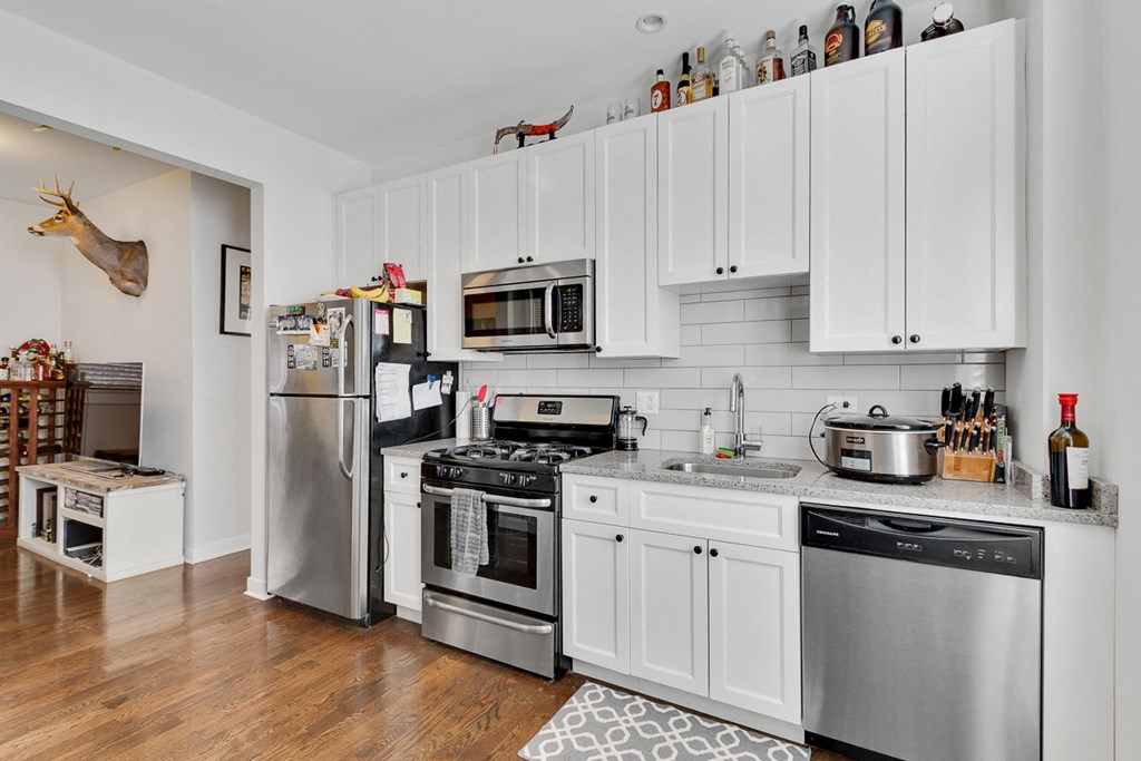 a kitchen with stainless steel appliances and white cabinets