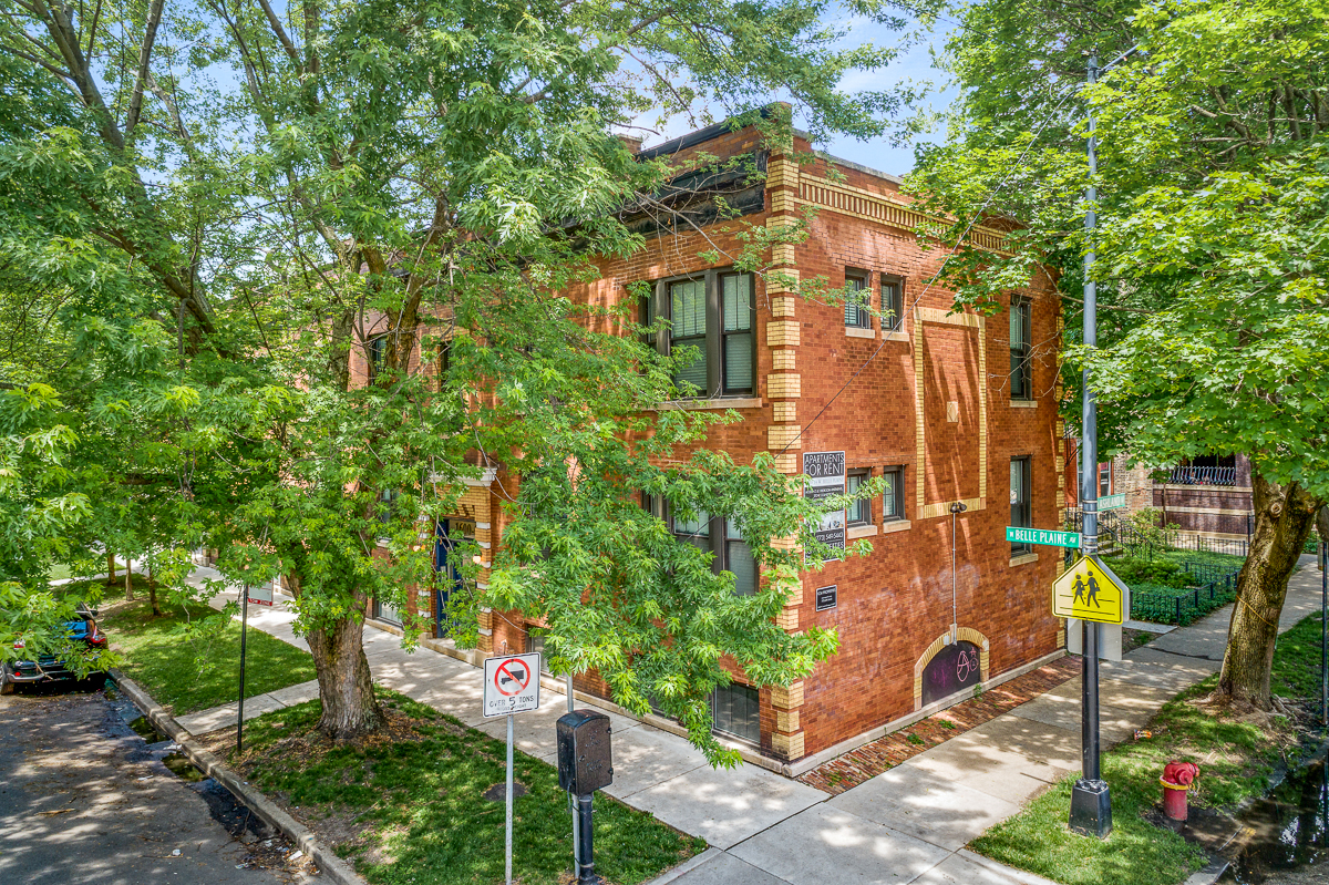 a red brick building with trees in front of it