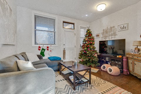 a living room with a christmas tree and a couch