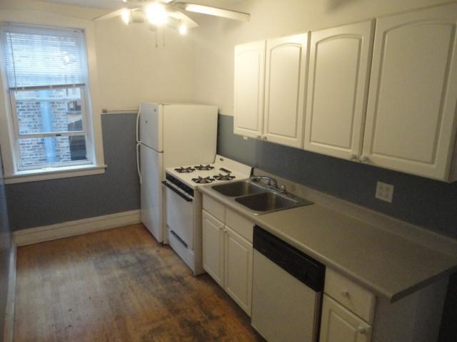 a kitchen with a stove and a sink and a refrigerator