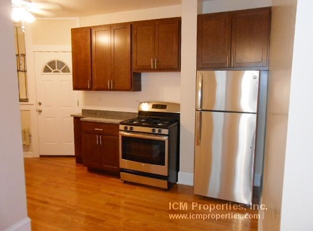 a kitchen with stainless steel appliances and wooden cabinets