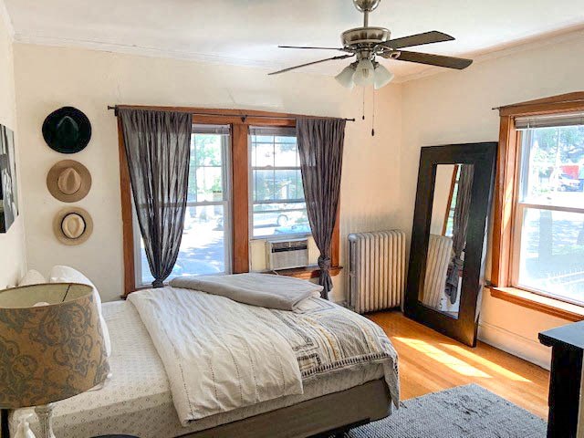 a bedroom with a bed and a ceiling fan