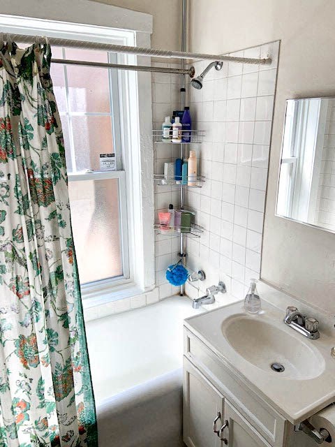 a bathroom with a shower curtain and a sink