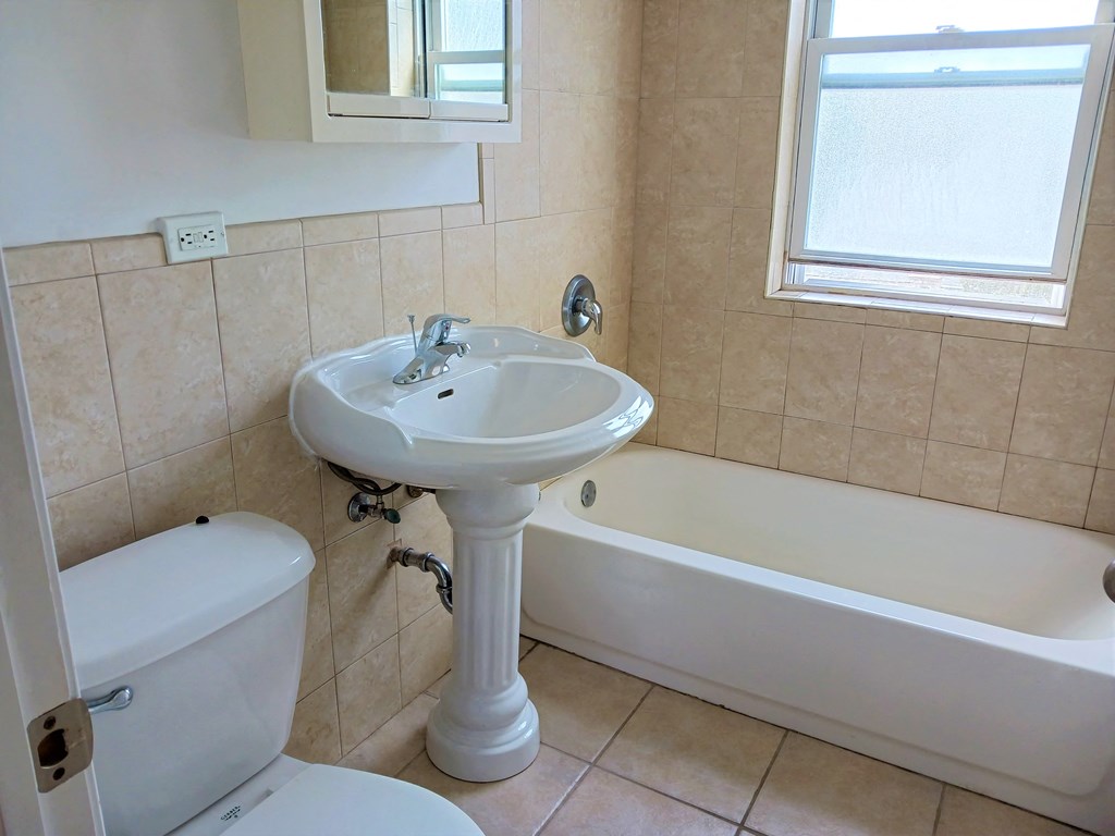 a bathroom with a sink and a tub and a toilet