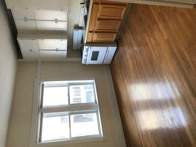 an overhead view of a room with a microwave and a window