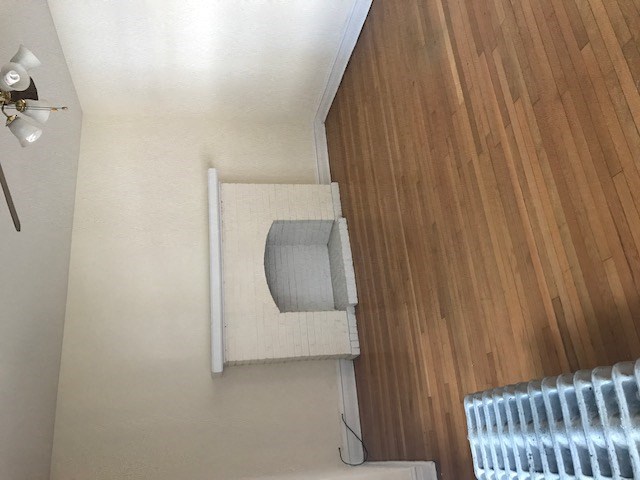 an overhead view of a small room with a window and a wood floor