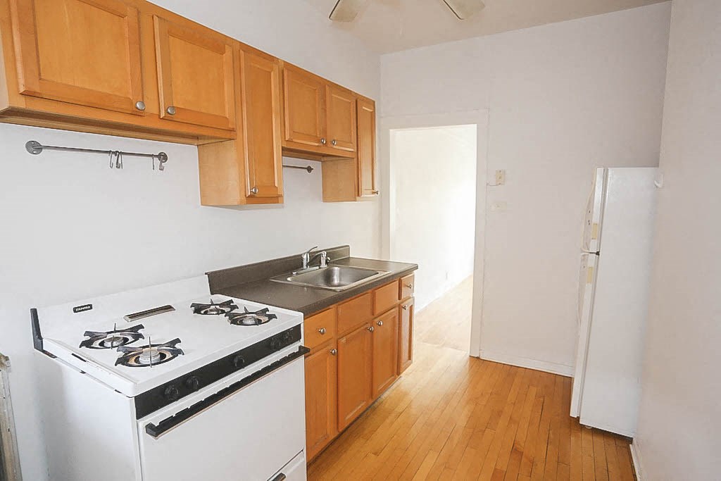 a kitchen with a stove and a sink in it