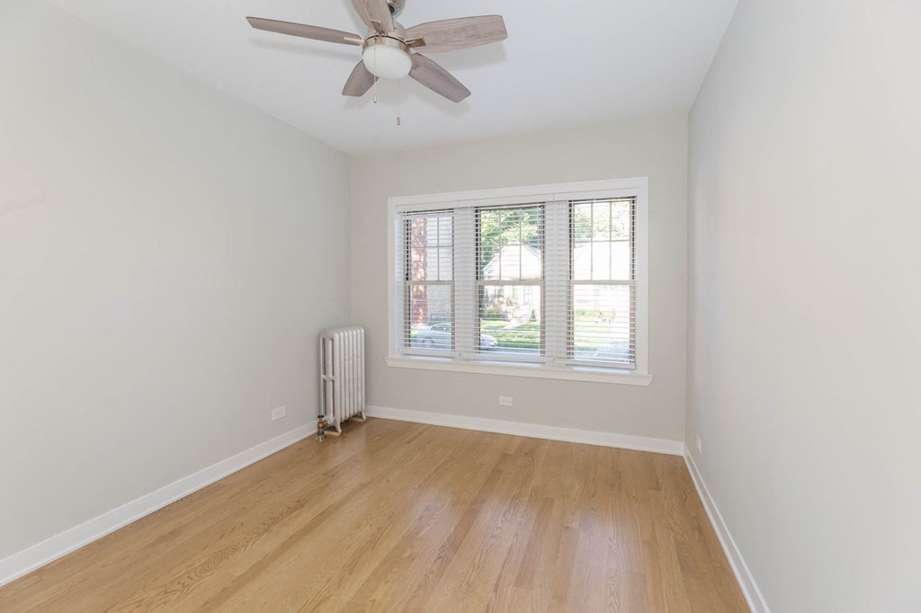 a living room with a ceiling fan and a window