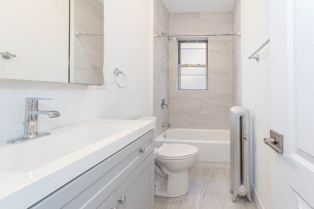 a white bathroom with a sink and a toilet