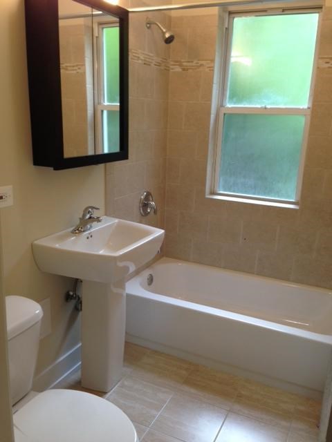 a bathroom with a sink toilet and a bath tub