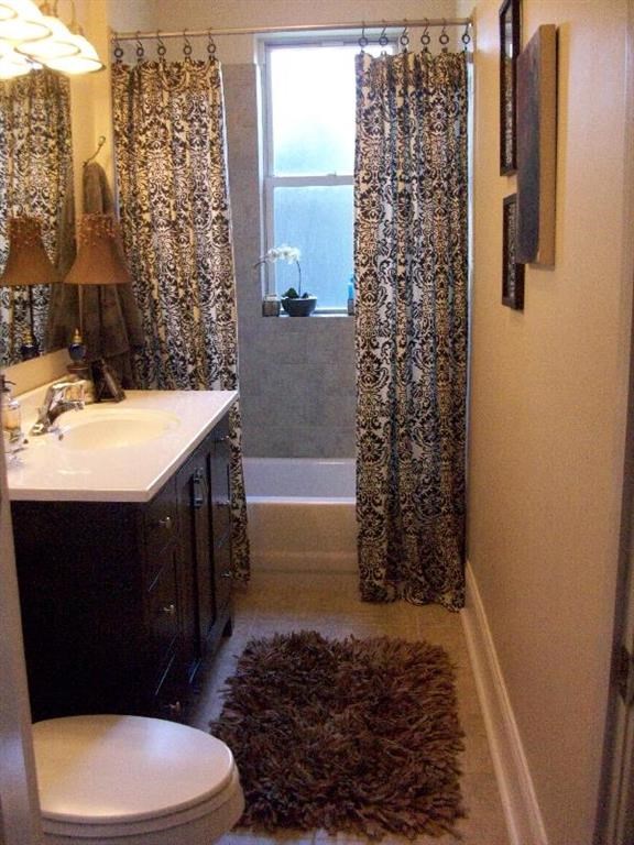 a bathroom with a toilet and a shower curtain