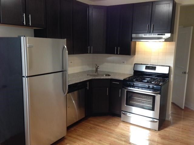 a kitchen with a stove and a refrigerator