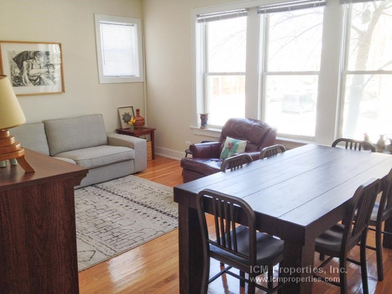 a living room with a wooden table and chairs