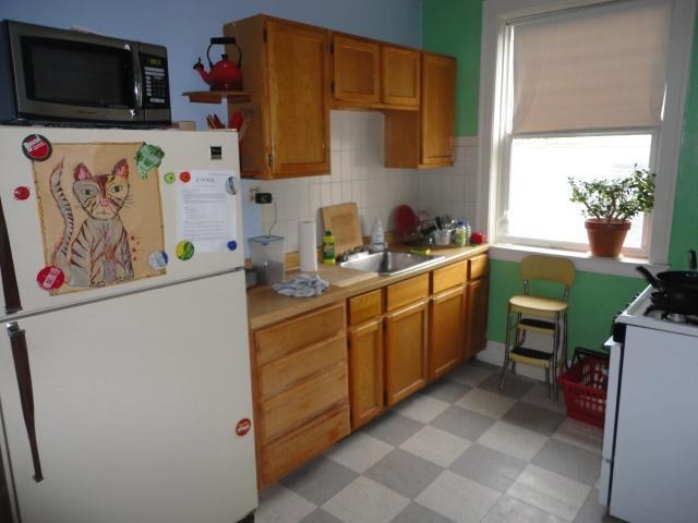 a kitchen with a refrigerator and a sink